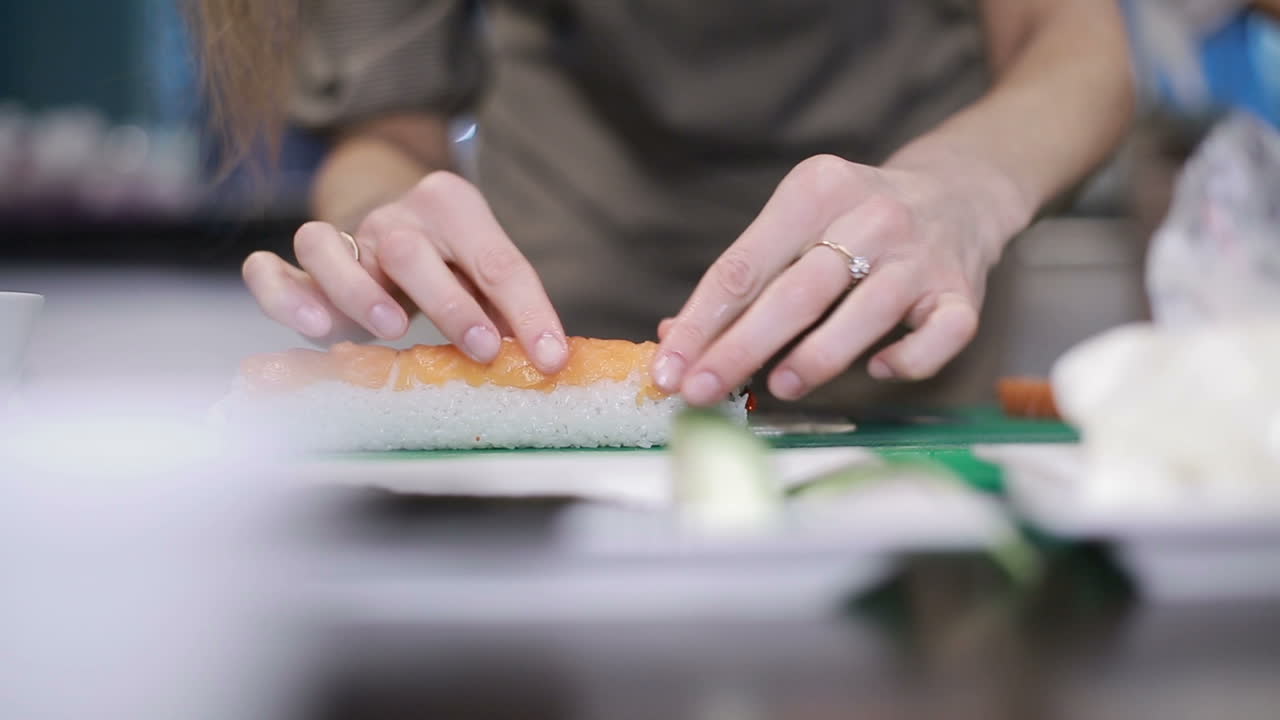 Sushi Roll Process. Closeup of chef hands preparing japanese food