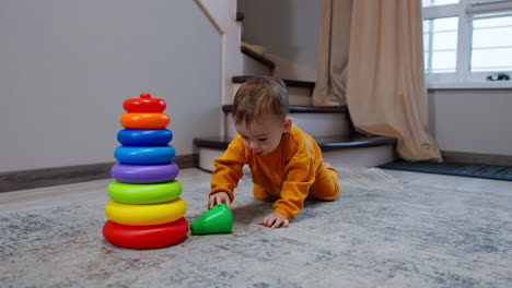 toddler playing with stacking rings and balls