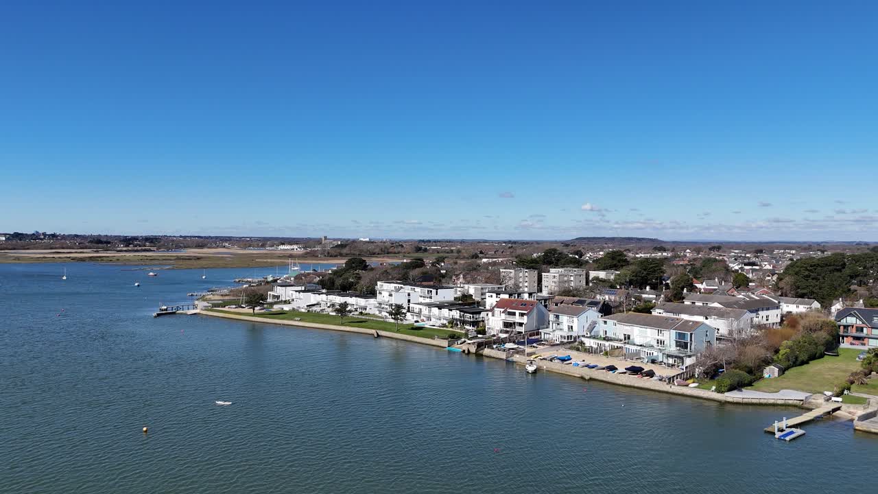Panning drone aerial Large Waterfront houses Mudeford Christchurch UK blue sky