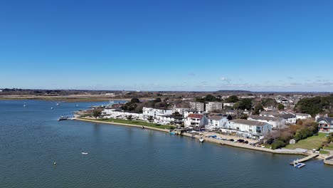 panning drone aerial large waterfront houses mudeford christchurch uk blue sky