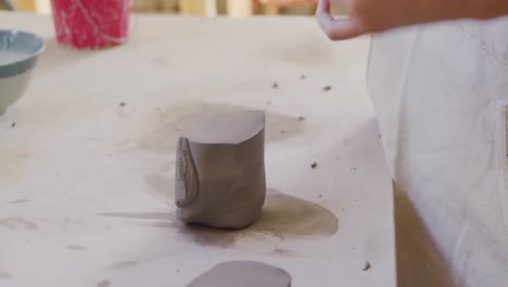 young female potter working in her studio