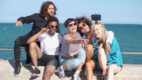 Happy-friends-posing-for-selfie-on-seafront