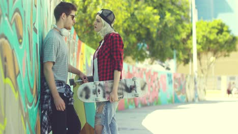 trendy young couple chatting in an urban street