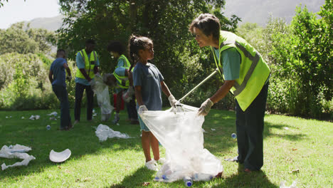 Happy-family-cleaning-a-garden-together