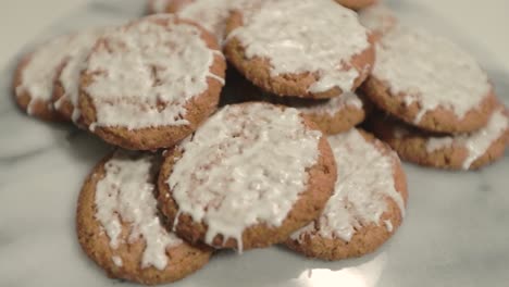 deliciously iced oatmeal cookies on a marble plate