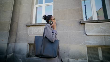 businesswoman walking and talking on phone