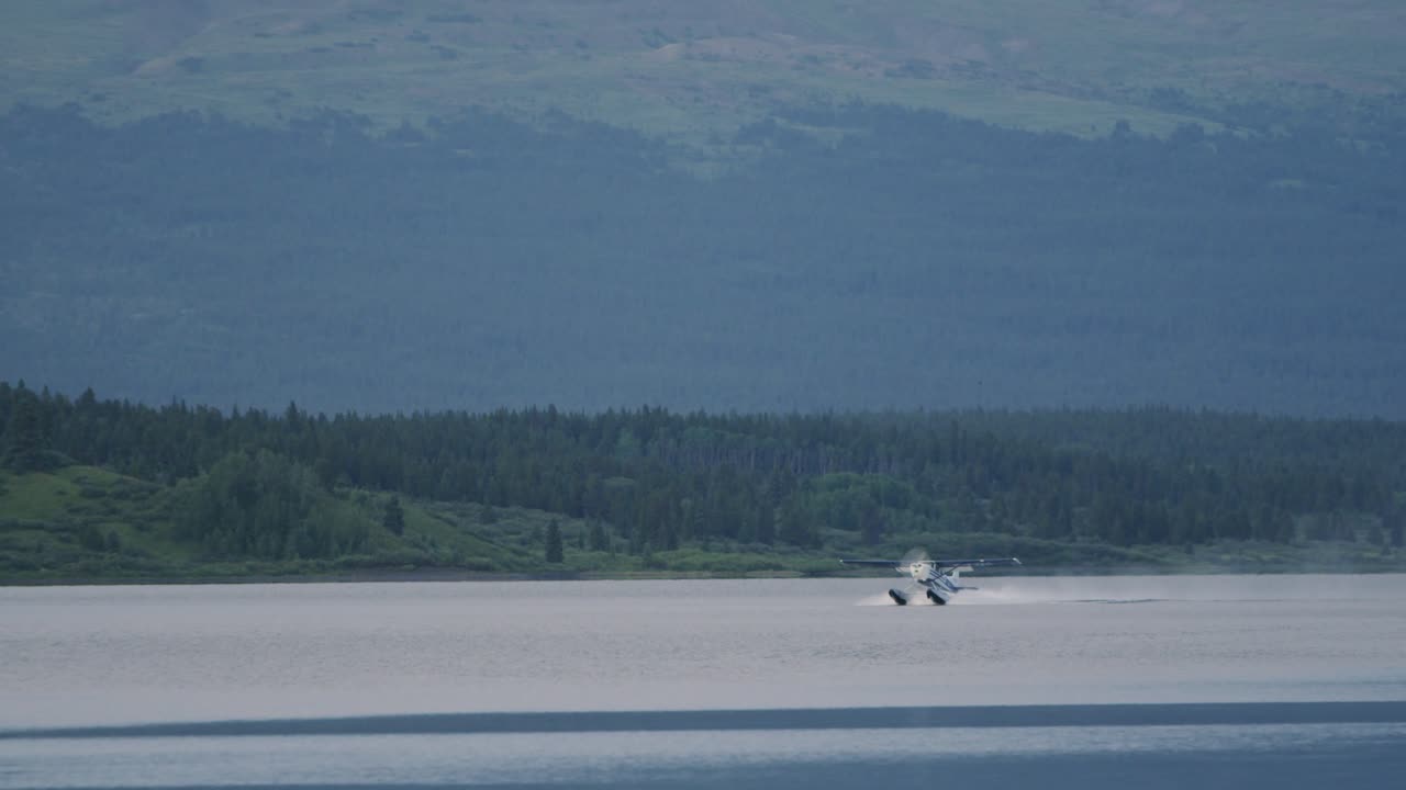 Float Plane taking off in slow motion from a remote lake