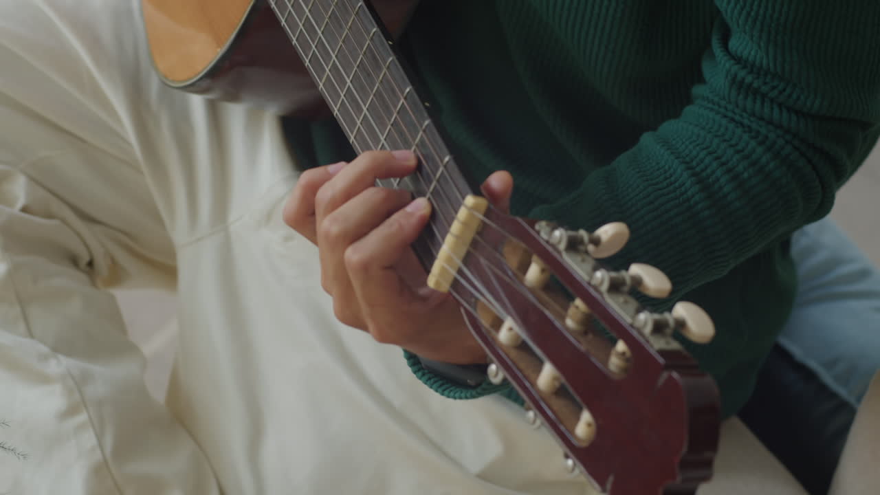 Unrecognizable Musician Playing Guitar Indoors