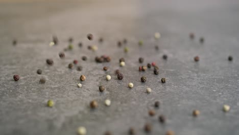 detail video of colored pepper falling on a kitchen counter