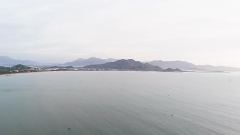 aerial view dolly of the coast and the mountains in phan rang–tháp chàm.