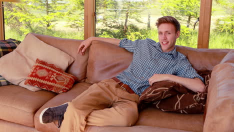 handsome young man relaxing on his couch