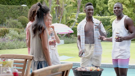 diverse friends enjoy a barbecue outdoors