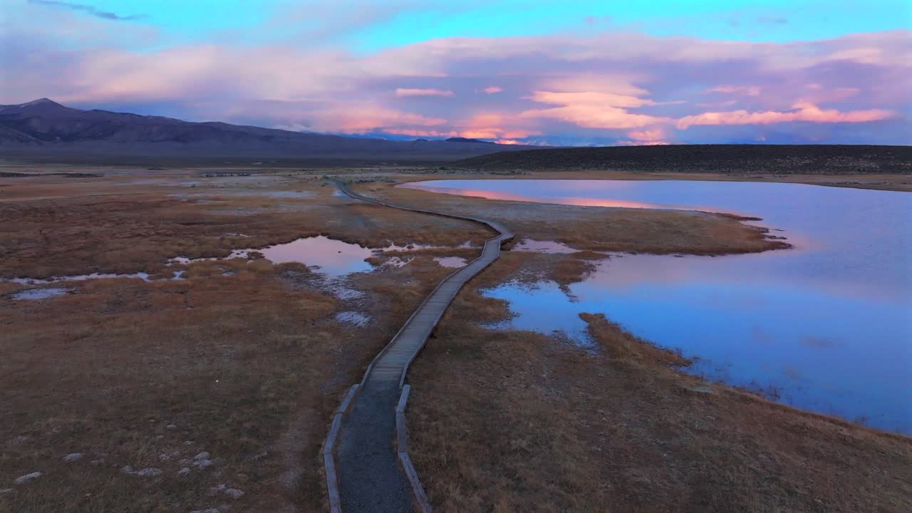 Wild Willy's Hot Springs boardwalk Mammoth Lakes California aerial drone winter vibrant dusk sunset clouds Benton Crossing Lake Crowley Long Valley Caldera valley birds flying forward motion