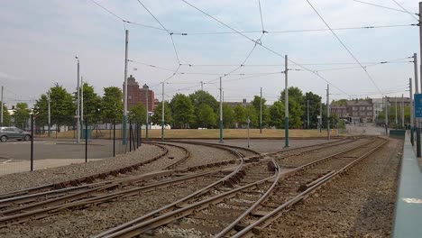 Tram-tracks-curving-at-a-park-and-ride-area-in-the-city-of-Nottingham-in-Nottinghamshire,-England,-United-Kingdom