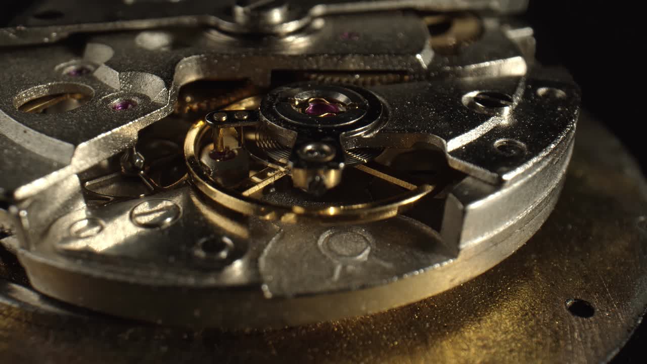 The mechanism of the vintage watch in the dark background, close-up. The concept of workshops for the repair and manufacture of watches.