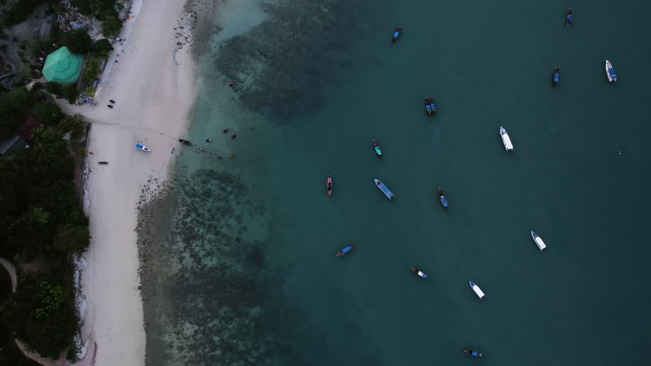Top down aerial over boats and the Loh Jark Pier on Koh Yao Yai, dusk in Thailand