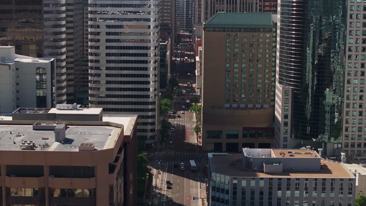 Aerial view of a street in Downtown Denver, surrounded by tall skyscrapers