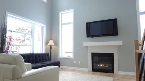 modern living room with tall ceiling reveal to show bright cute fireplace