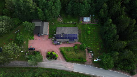 time-lapse drone shot of clouds moving over a family house powered with solar cells