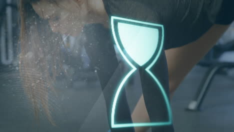 animación de un reloj de arena giratorio sobre una mujer caucásica haciendo estiramientos antes de hacer ejercicio en el gimnasio