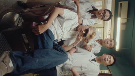 team of asian barbers posing for camera in the barbershop