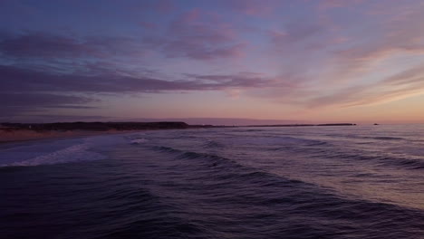 wavy sea at pink sunset