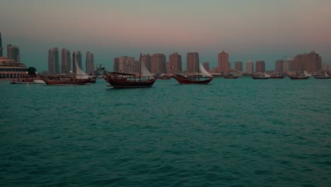 dhows with qatar flag in arabic gulf sunset shot