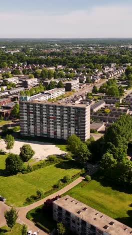 aerial view of a large residential building in an urban green neighborhood