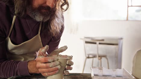 male potter making pot