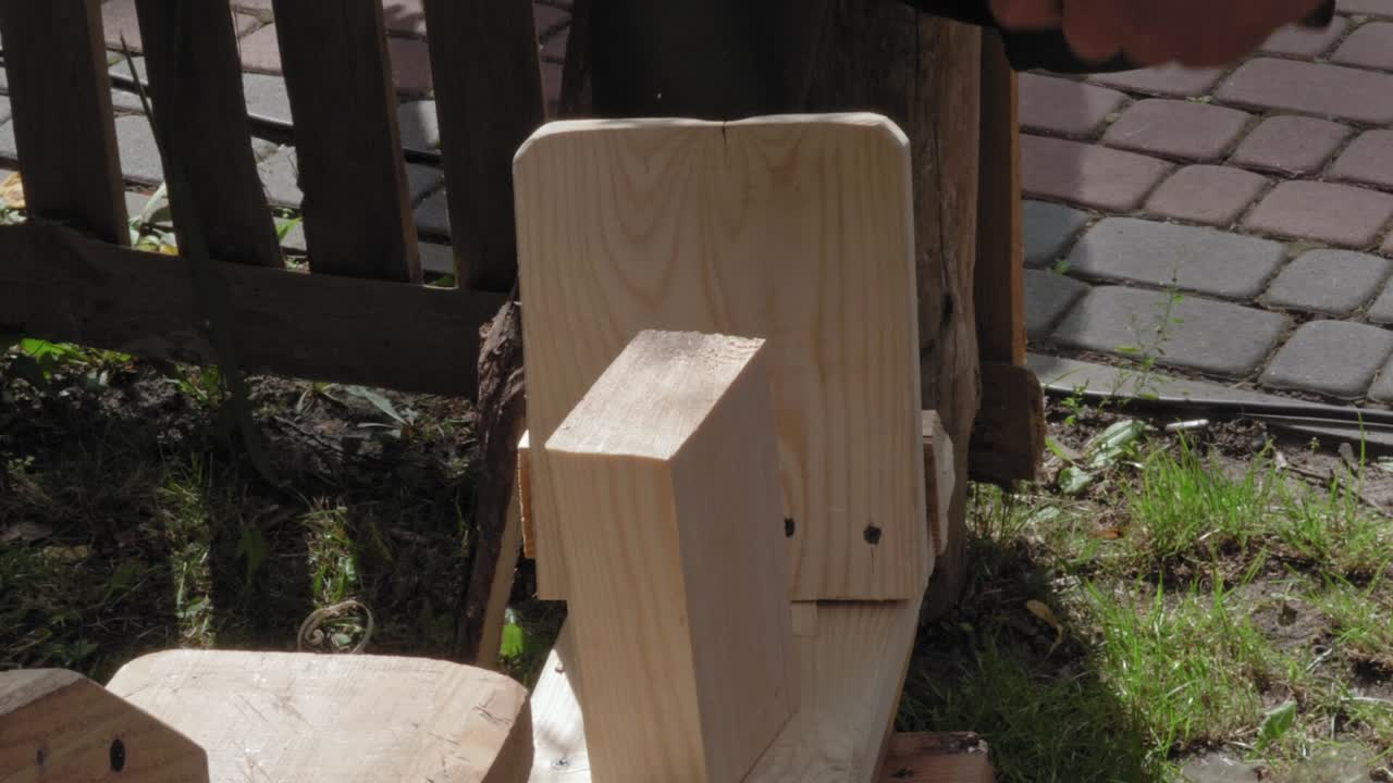 Man Hand Carving Wood with Axe and Saw