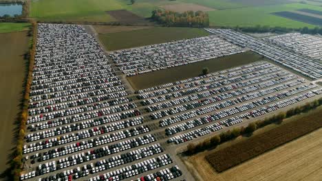 Aerial-footage-of-finished-cars-ready-to-be-shipped-on-huge-distribution-center