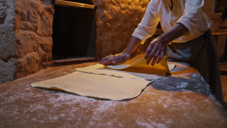 woman making traditional bread in a stone oven