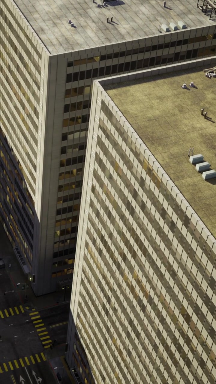 Vista de dois edifícios altos e ruas abaixo em uma cena urbana.