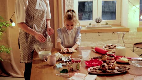 mother and daughter baking cookies