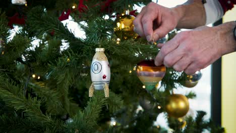 hanging heart and space rocket decoration on artificial christmas tree