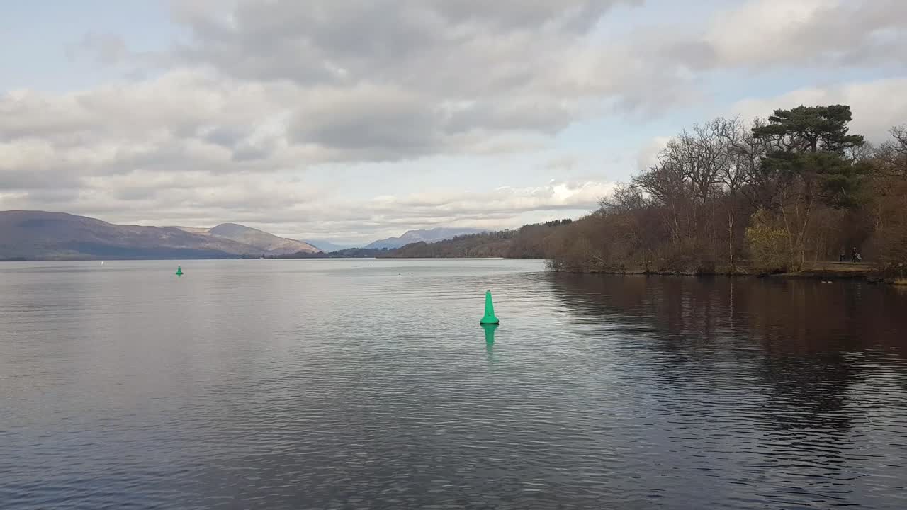 Shot from a boat gliding across Loch Lomond in Scotland’s Trossachs National Park on a cloudy winter day, capturing the moody beauty of the Highlands