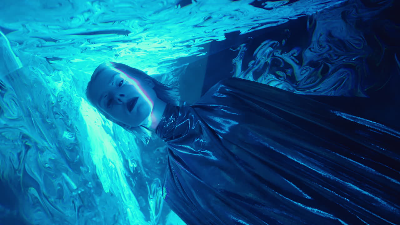 Woman in Silver Dress Posing in Laser Light Tunnel