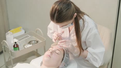 cosmetologist performing facial injection procedure