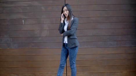 stylish trendy woman chatting on a mobile