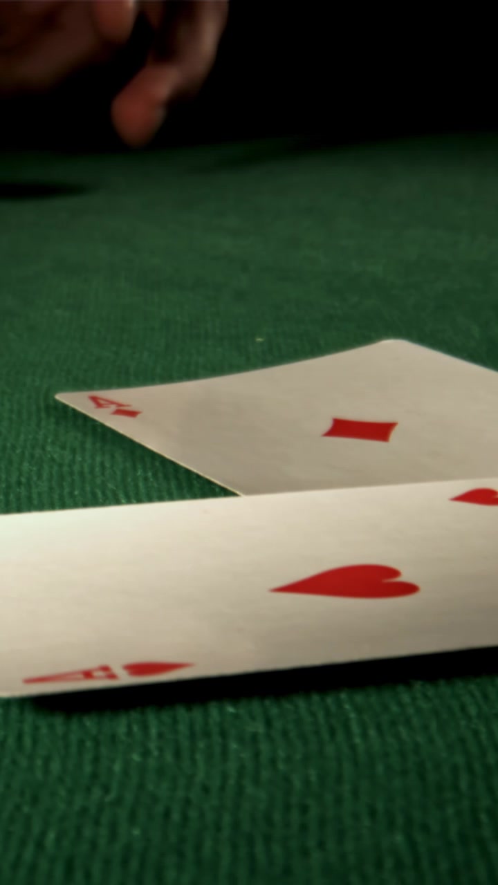 Two Aces Dealt on a Green Felt Poker Table