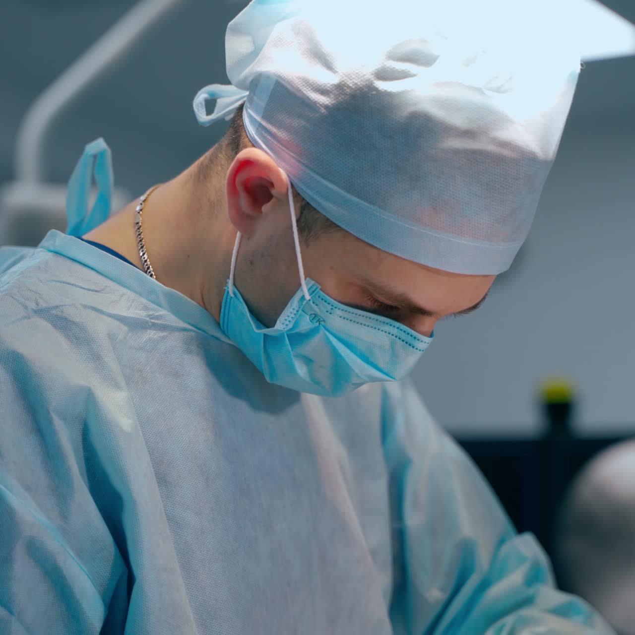 Professional surgeon in medical uniform. Medical specialist performing an operation with modern instruments in the operating theater.