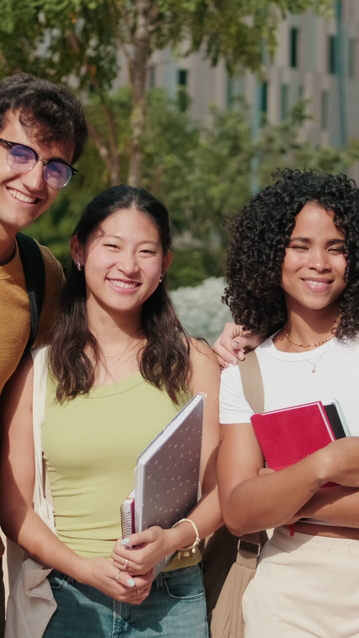 Diverse group of teenage student friends standing together, having fun smiling