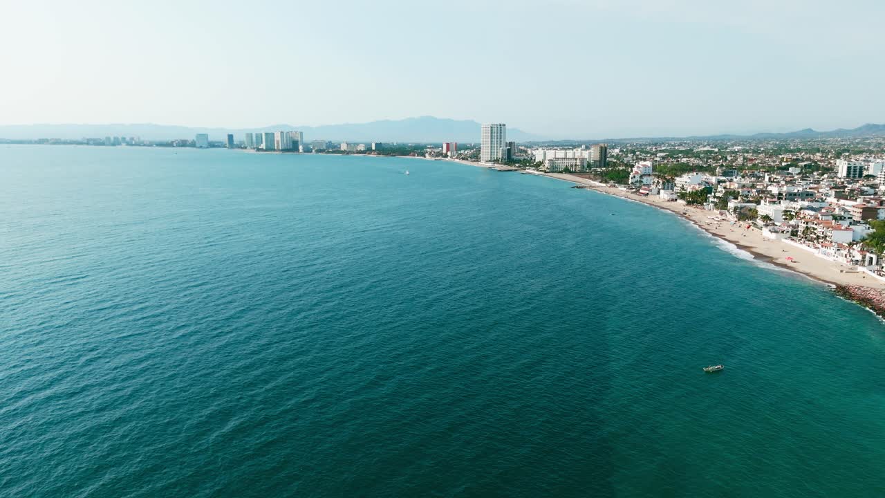 Scenic coastline of puerto vallarta with vibrant buildings and lush hills. Mexico, aerial view