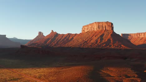 moab, utah cliffs and sandstone buttes during golden hour, drone push in shot