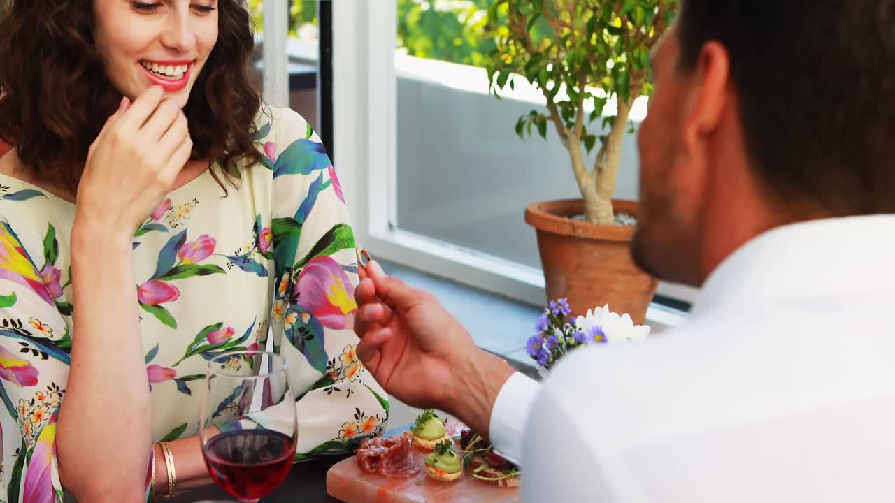 Man proposing woman with engagement ring
