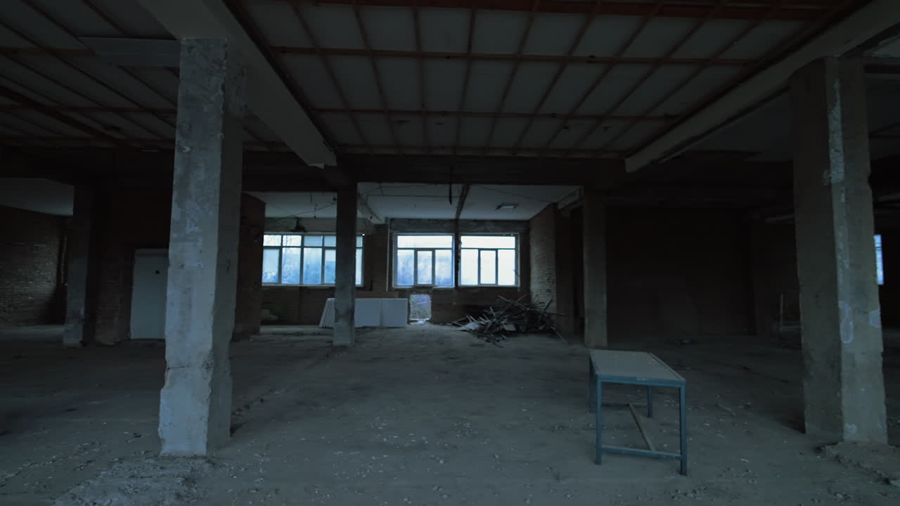 Overlook of the large premise in the building being constructed or reconstructed. Interior with some debris and scaffolding.