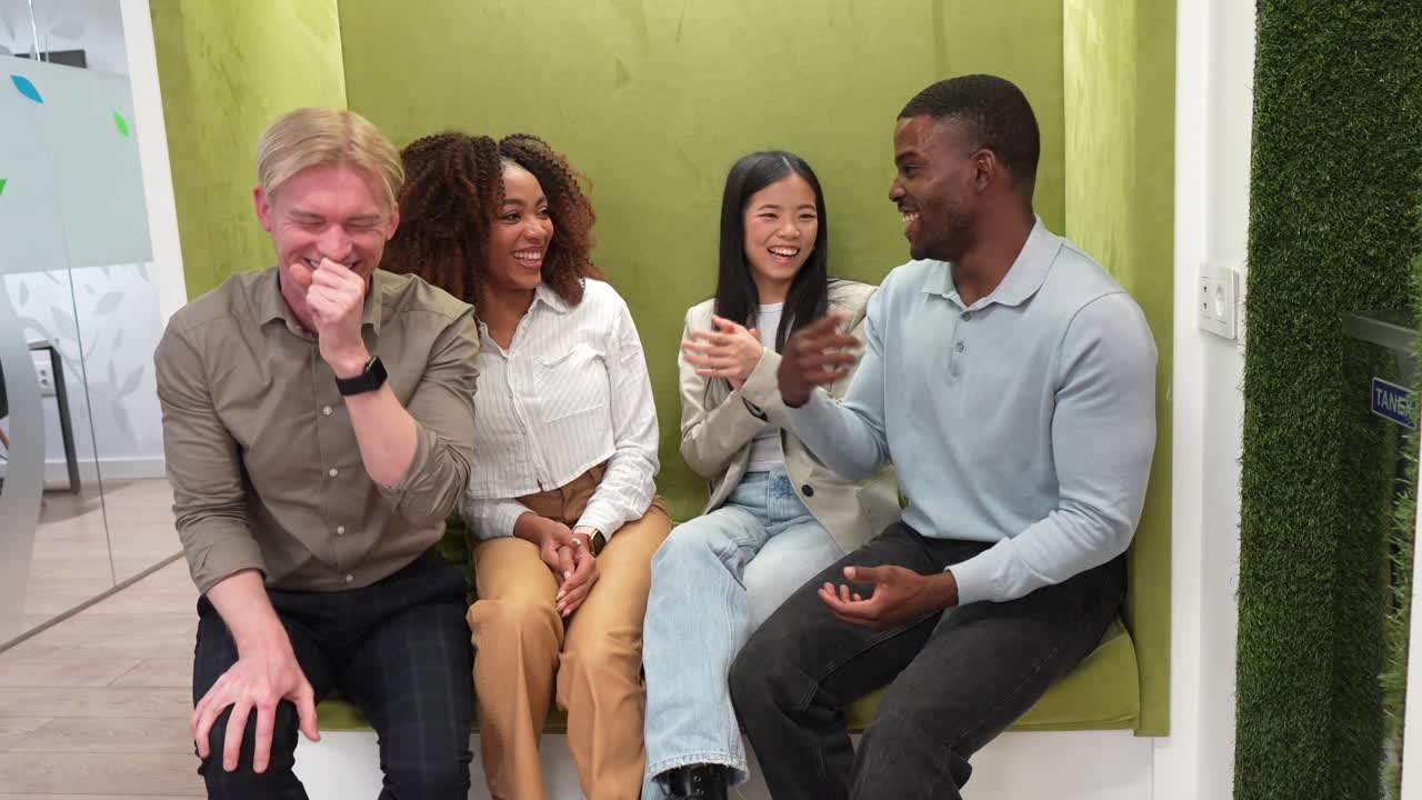 Group of diverse friends having a conversation in the office