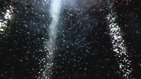 top-down backwards aerial movement over the awesome big crowd on live electronic music festival.