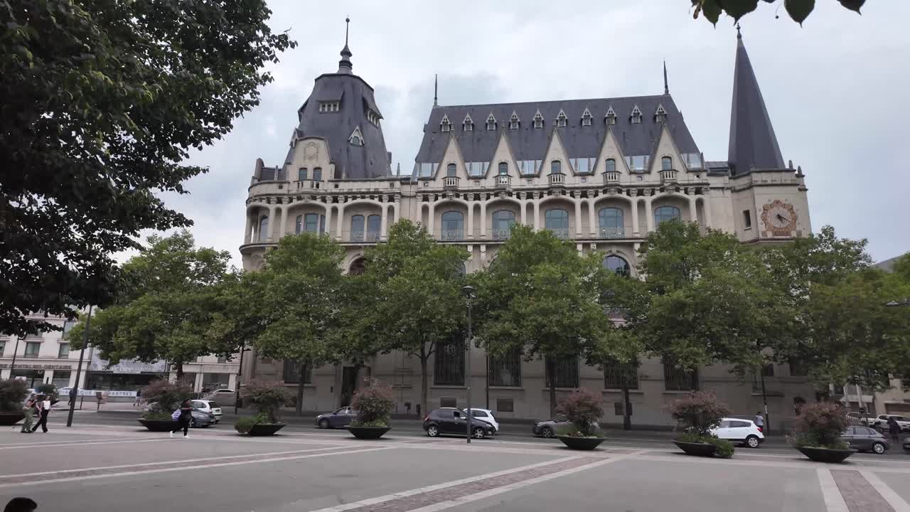 Chartres impressive architecture, Library Mediatheque the view through tree branches and public space with benches. France.
