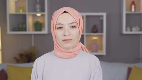 muslim woman in hijab looking at camera.